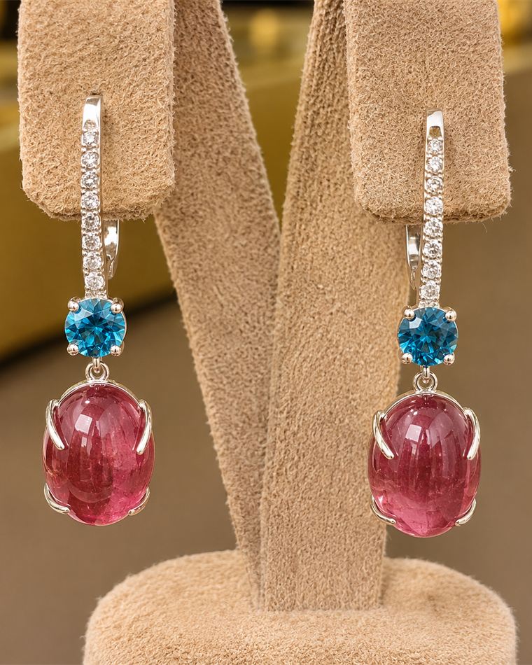 Rose tourmaline cabochon drop earrings with blue topaz accents